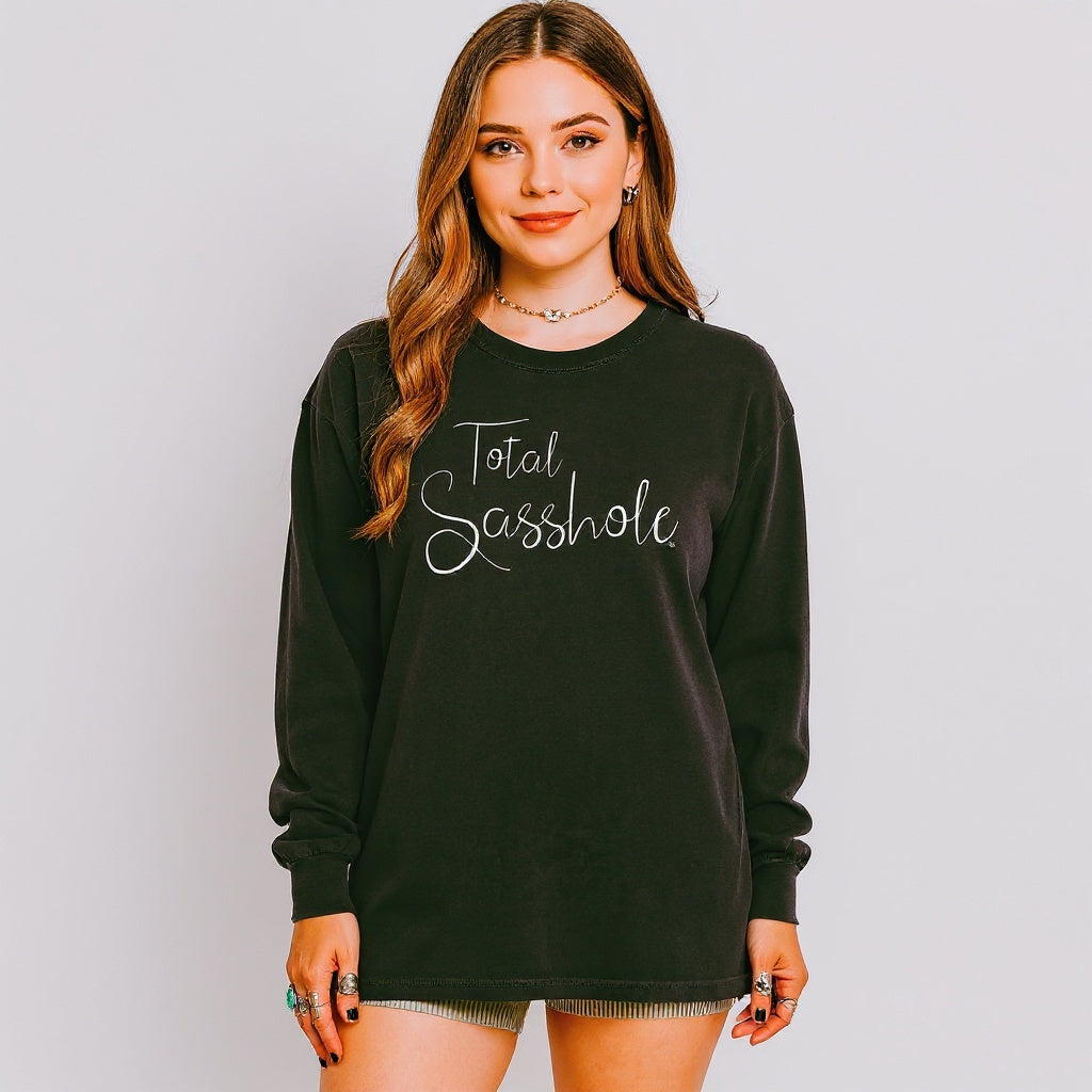 Woman wearing a black long sleeve t-shirt with 'Total Sasshole' text on a plain background