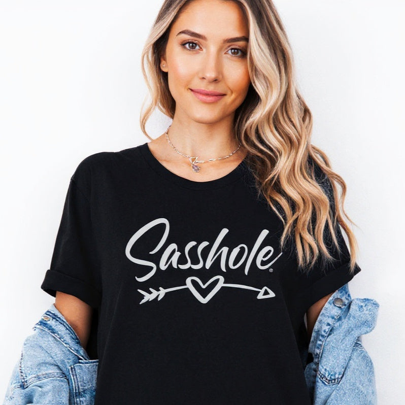 Person wearing a black t-shirt with 'Sasshole' text and an arrow graphic.