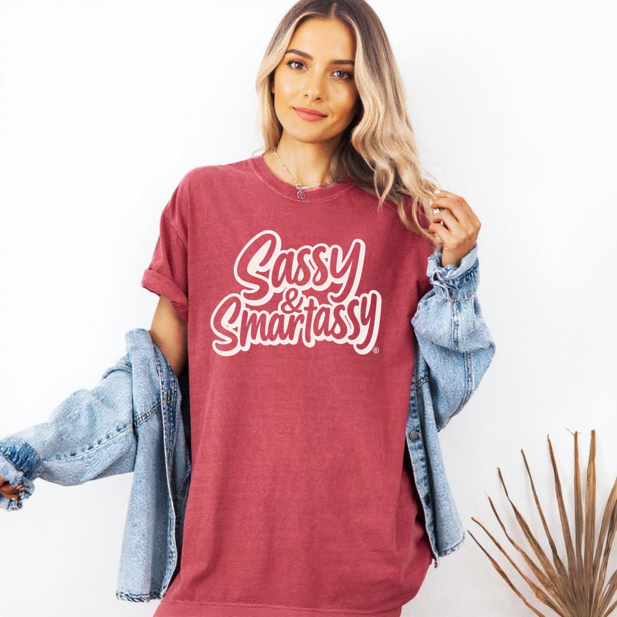 Image of Woman wearing a red t-shirt with 'Sassy & Smartassy' text, standing against a white background.