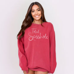 Image of Woman wearing a red sweatshirt with 'Total Sasshole' text on a white background