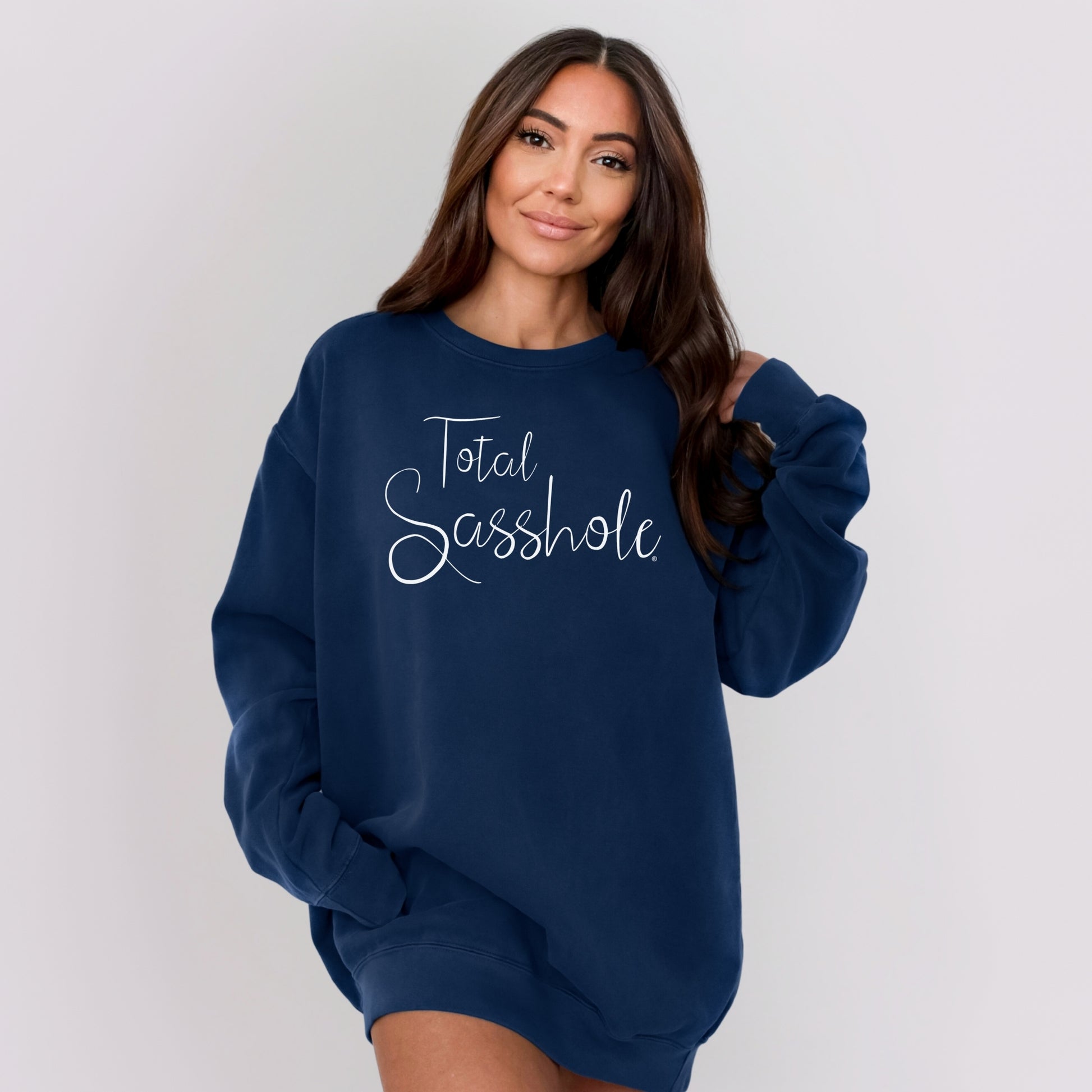 Person wearing a navy blue sweatshirt with 'Total Sasshole' text on a plain background