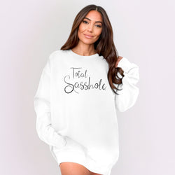 Image of Woman wearing a white sweatshirt with 'Total Sasshole' text on a plain background