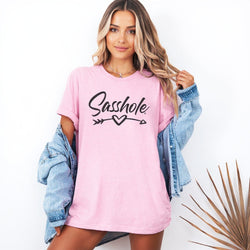 Image of Person wearing a pink oversized shirt with text and a denim jacket on a white background